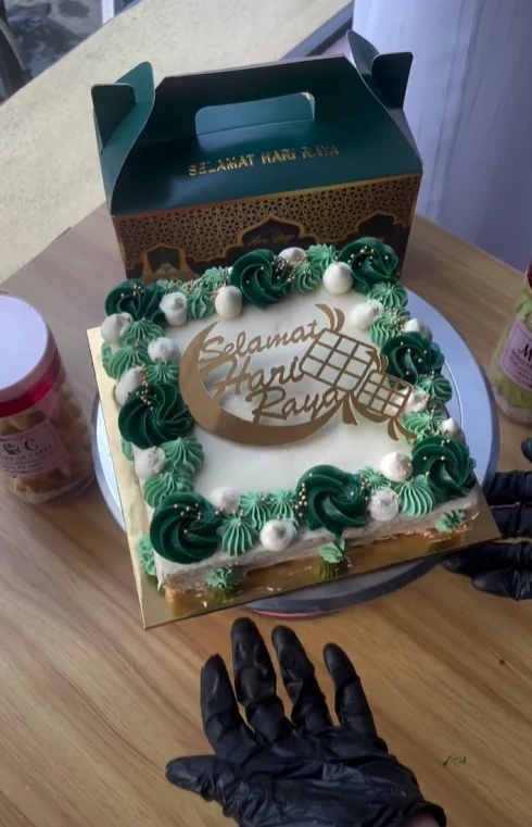 Green and white Hari Raya celebration cake with ketupat topper